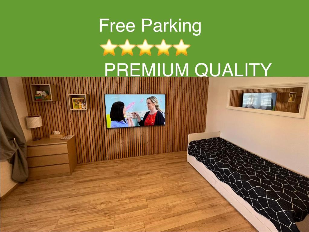 a bedroom with a tv with five stars on it at APARTMENTS TRENČÍN -Free Parking- in Trenčín