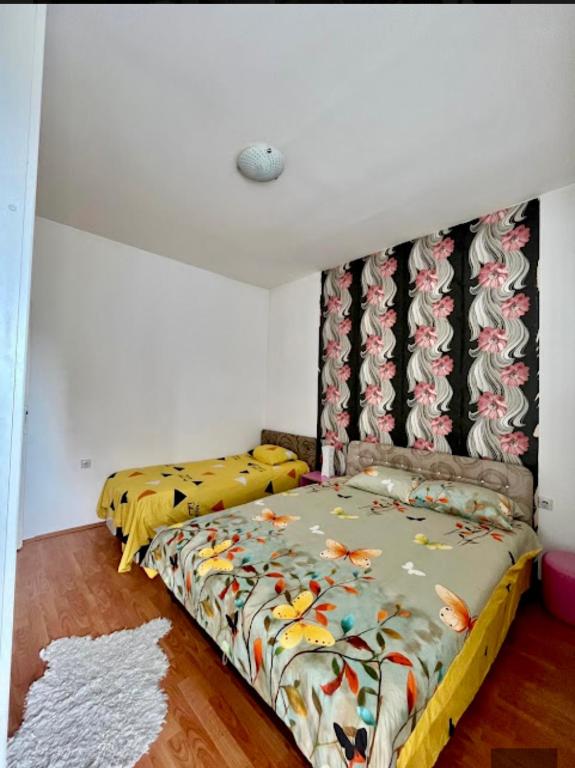 a bedroom with two beds in a room at Centar S in Pirot