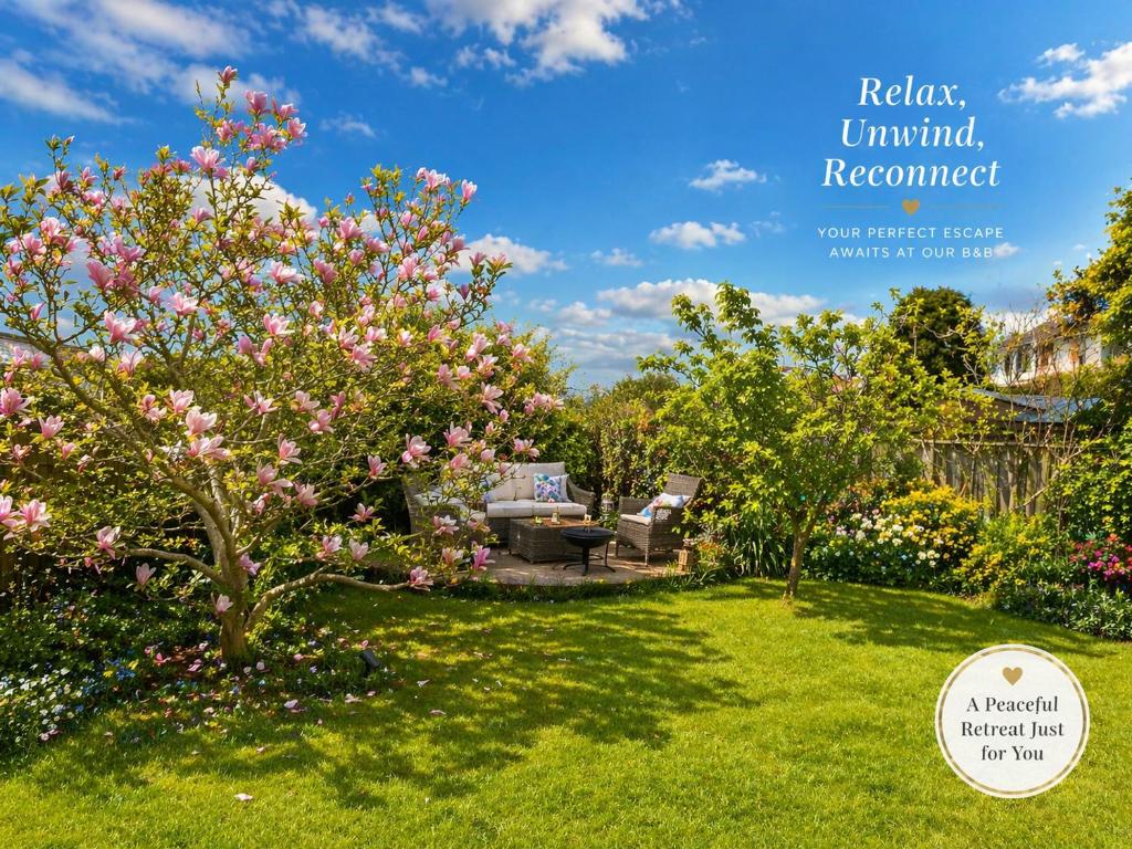 a garden with a magnolia tree in a yard at Greytree Cottage in Ross on Wye
