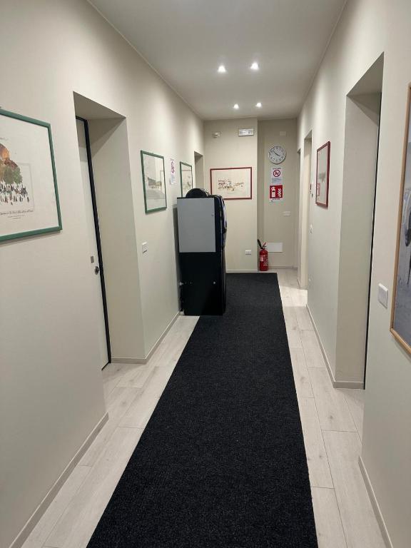 a hallway with a black refrigerator in a room at Locanda Patoea Alloggi in Borgoricco