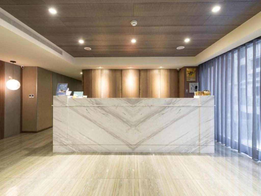 a lobby with a large marble counter in a room at 西門大飯店 Ximen Hotel in Taipei