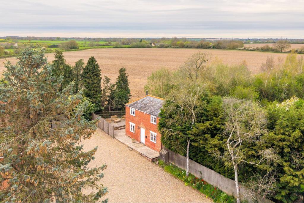 an aerial view of a house in a field at The Cottage at Tuffon Hall in Sible Hedingham