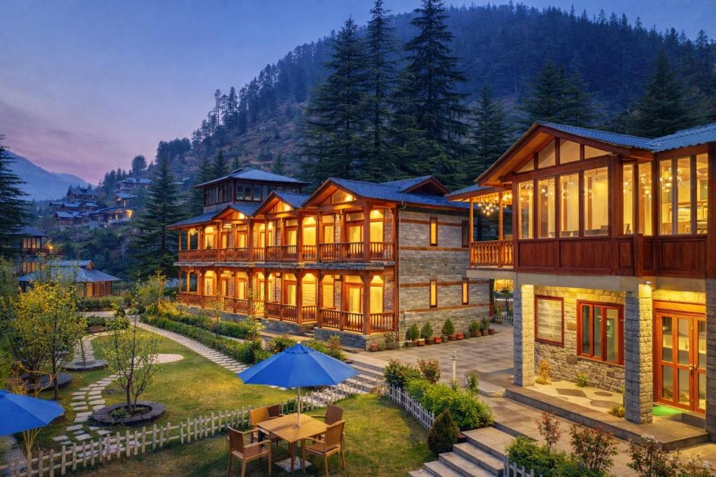 a large house with a lot of windows at 8fold by Larisa, Jibhi in Jibhi