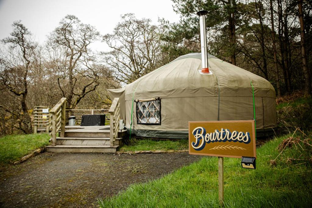 a yurt with a sign in front of it at Kelburn Yurts - Bourtrees in Fairlie