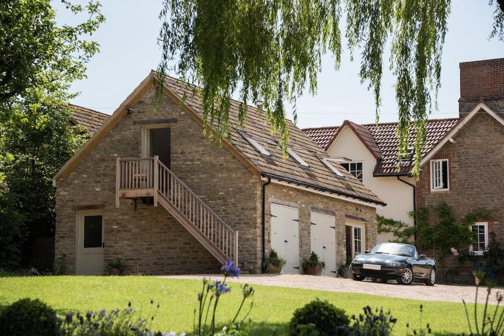 a house with a car parked in front of it at The Loft in Calne