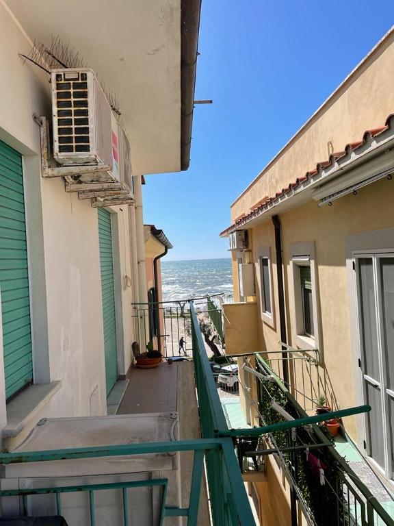 a balcony of a building with the ocean in the background at Casa GIGIA in Sperlonga