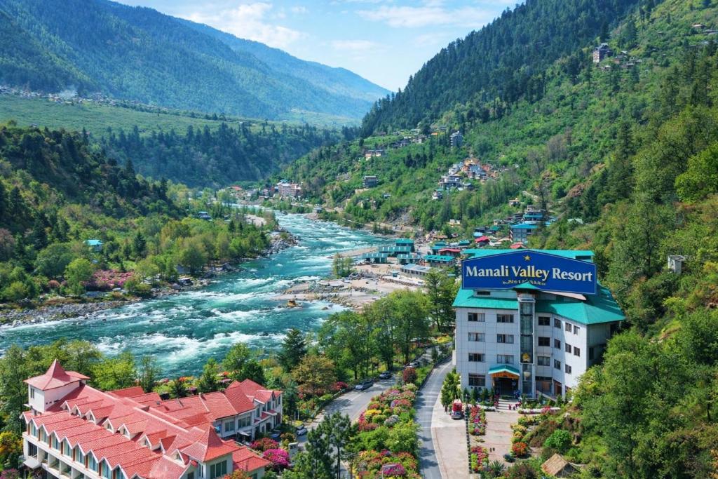 a view of the mountain valley resort and river at Manali Valley Resort in Manāli