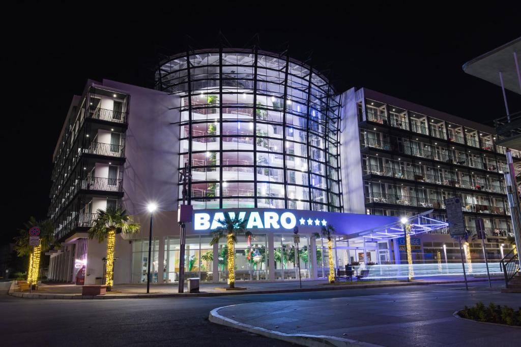 a building with a sign that reads bsymonto at night at Hotel Bavaro in Sunny Beach