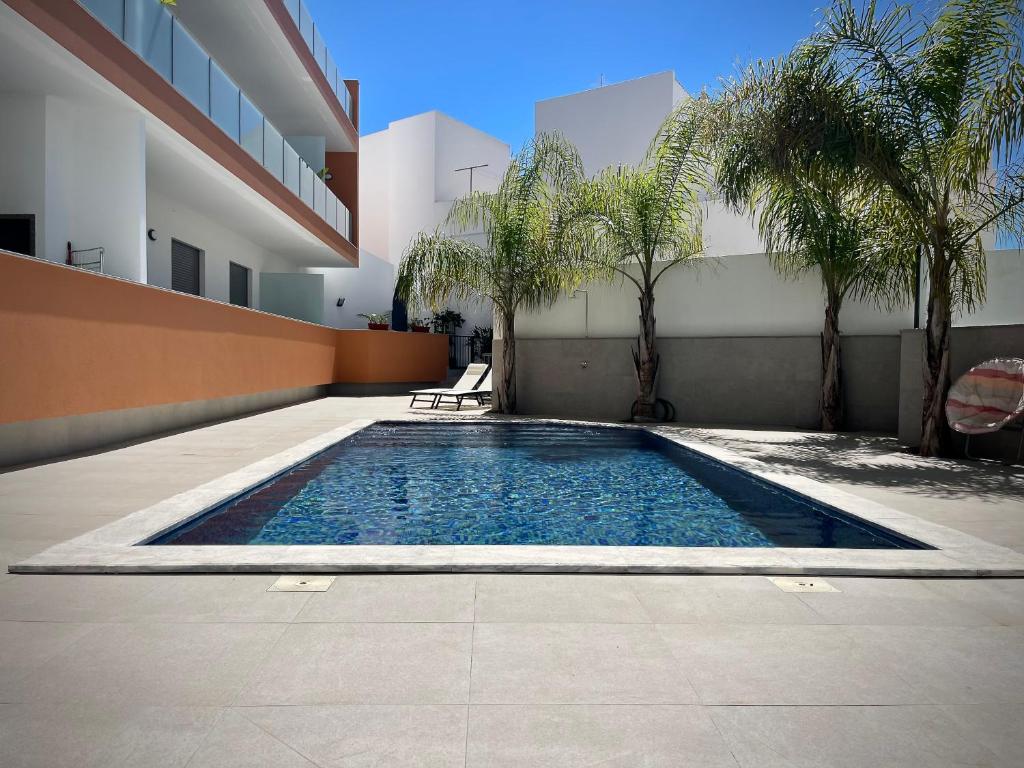 a swimming pool in the courtyard of a building at Apt IM - With pool, wifi and parking in Pêra