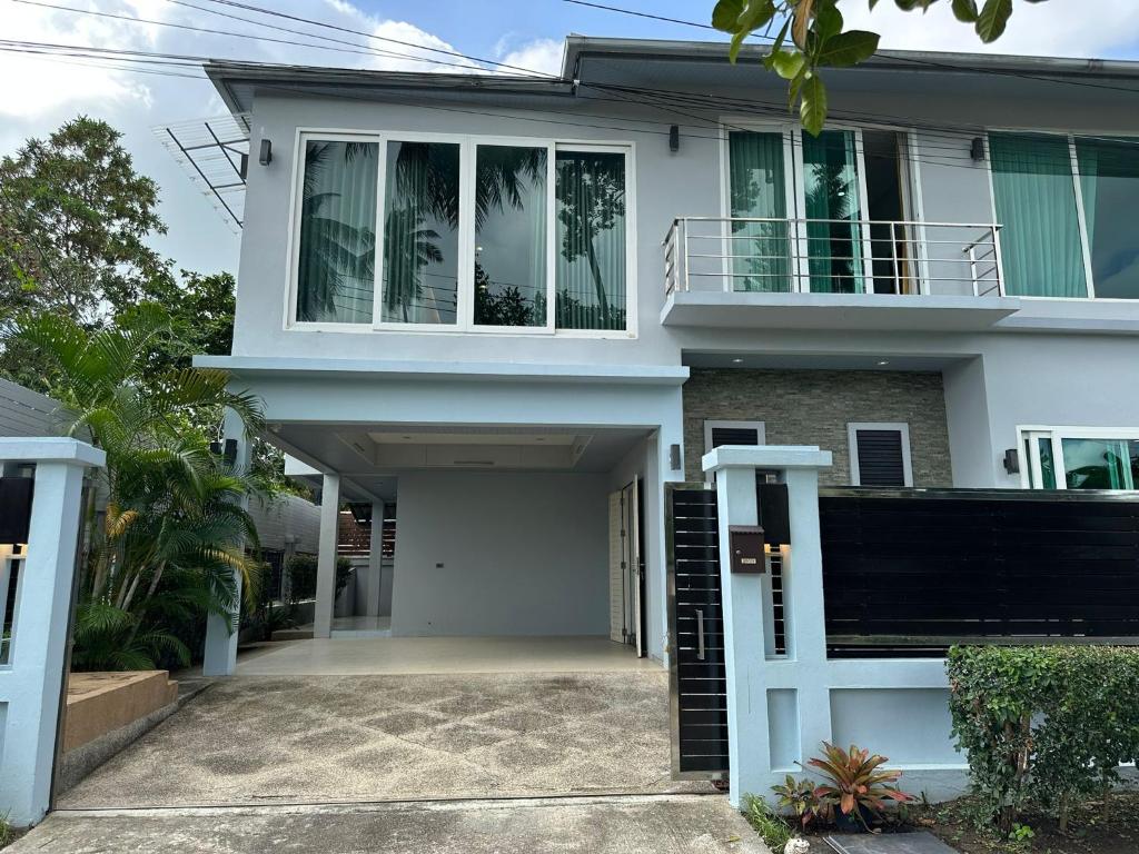 a white house with a balcony at Villa Worawan Pool Villa Bo Phut in Nathon Bay
