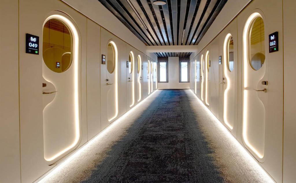 an empty hallway with lights on the walls at Wostel The Comfort Hostel in Málaga