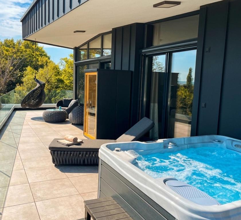a jacuzzi tub in the backyard of a house at Premium Penthouse in Keszthely