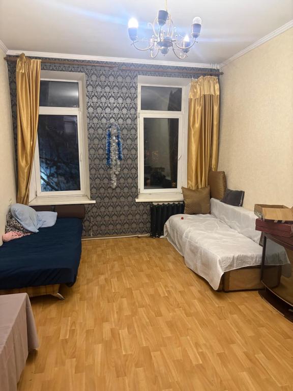 a bedroom with two beds and two windows at На Еврейской in Odesa