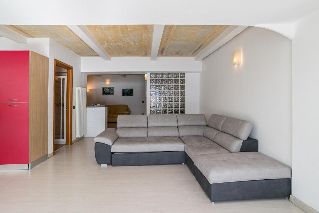 a living room with a couch and a kitchen at Menaggio Tosca Apartments in Menaggio