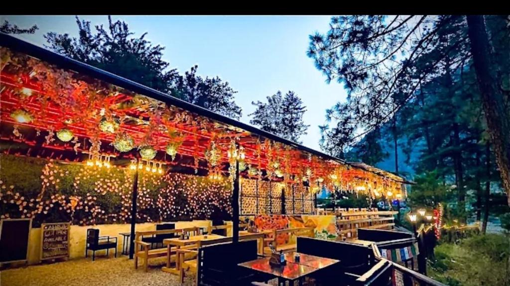 a restaurant with lights on the side of a building at Rivanta Resort Kasol in Kasol