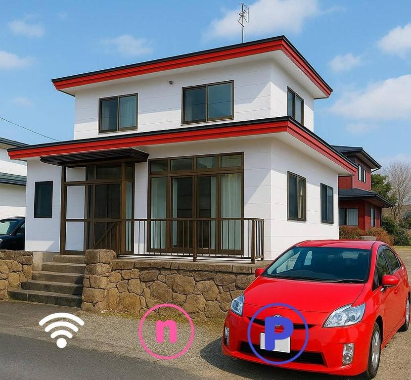 a red car parked in front of a house at Horomisou in Noboribetsu