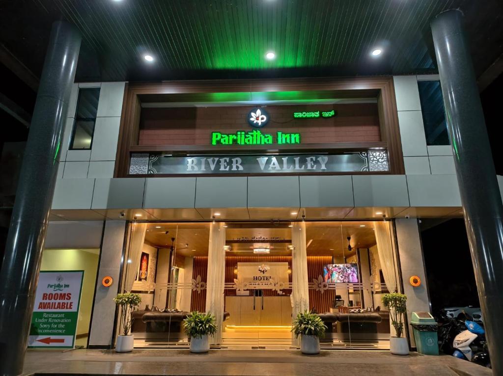 a building with a sign on the front of it at HOTEL PARIJATHA Inn in Dharmastala