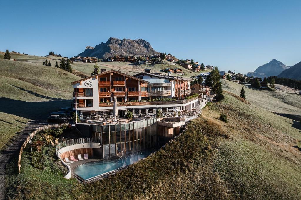 an aerial view of a house on a hill at Hotel Goldener Berg in Lech am Arlberg