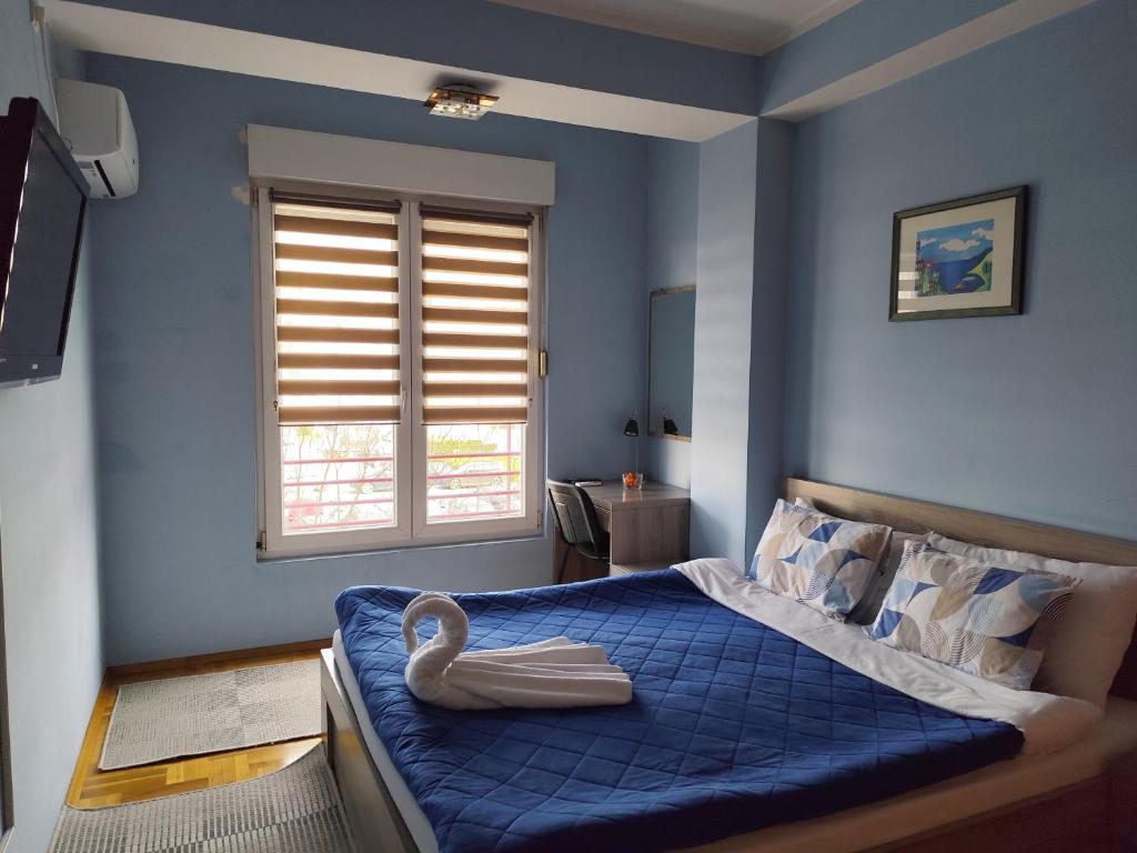 a bedroom with a bed with a swan on it at Apartment Temple in Podgorica