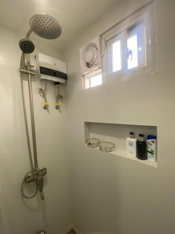 a shower in a bathroom with a window at Balai Mi Vigan in Vigan