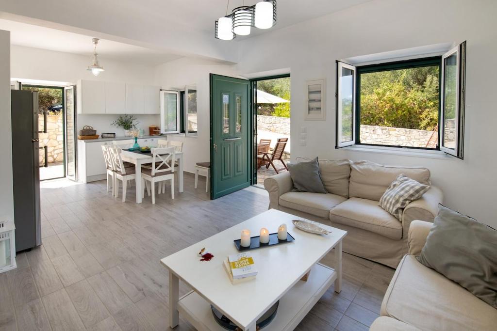 a living room with a couch and a table at Elaion Serenity in Lákka