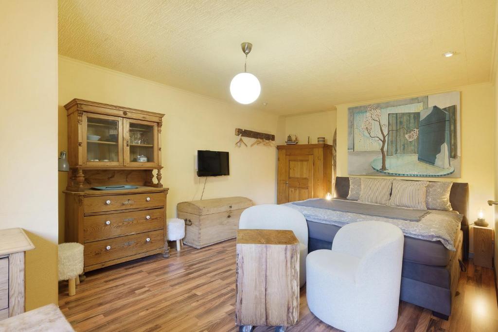 a bedroom with a bed and a dresser at Romantikzimmer in Striesen in Dresden