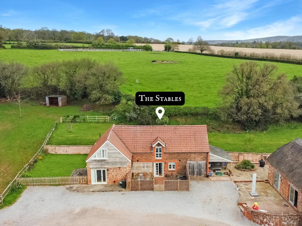 an aerial view of a house with a sign that reads the sticks at The Stables Lydeard St Lawrence in Combe Florey
