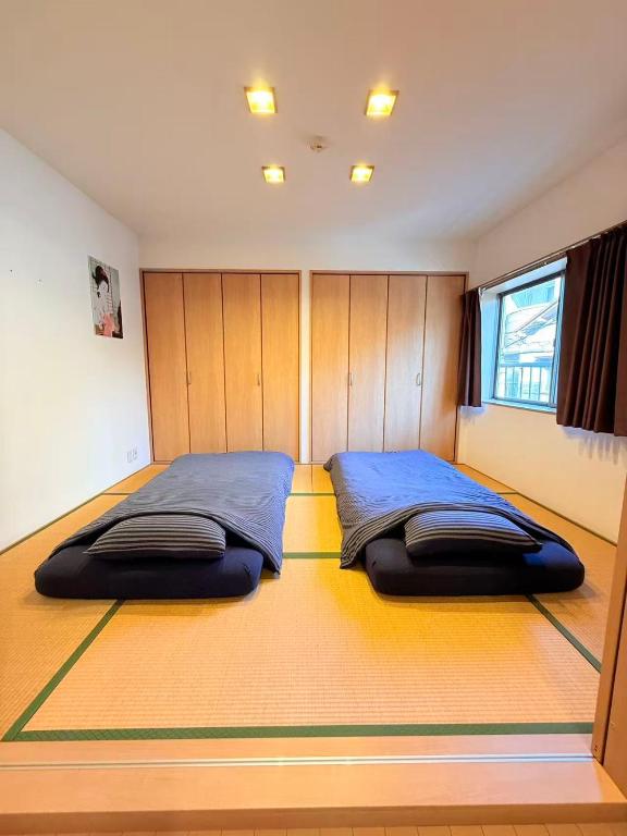 a bedroom with two beds in the middle of it at 十五夜 in Osaka