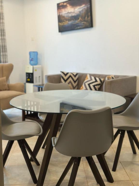 a dining room with a table and chairs at Homly Stays in Kisii