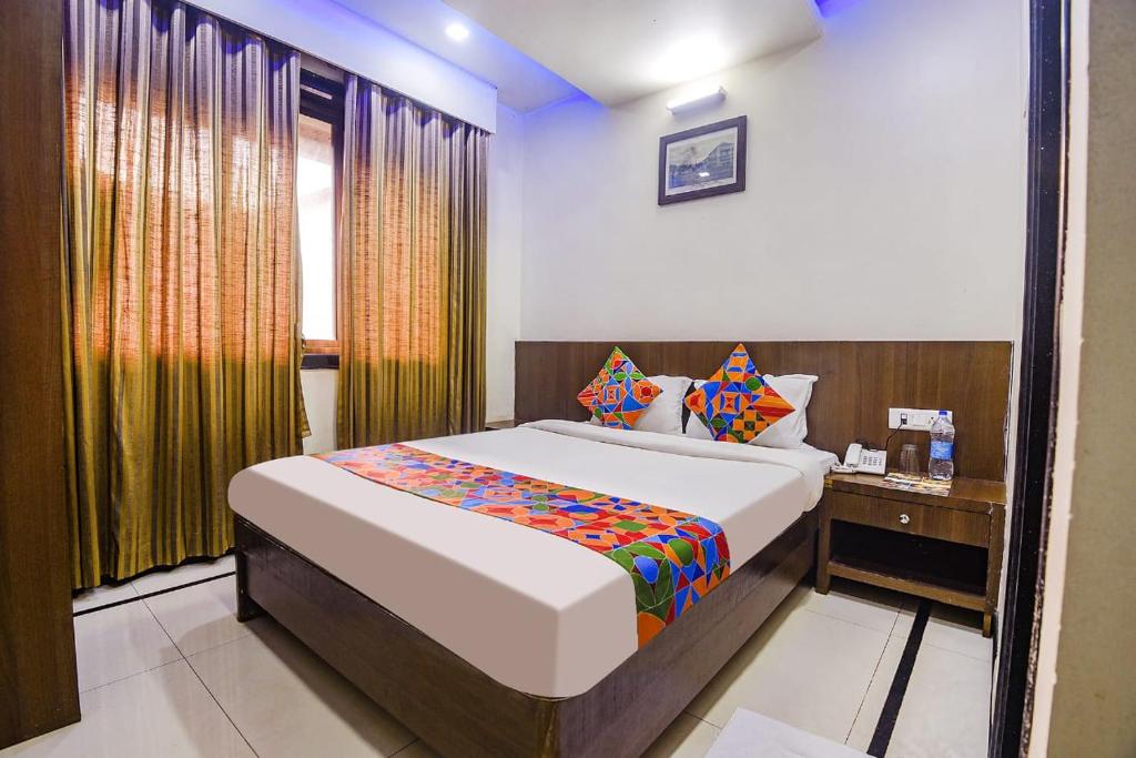 a bedroom with a large bed and a window at Hotel Shakti Palace in Ponda