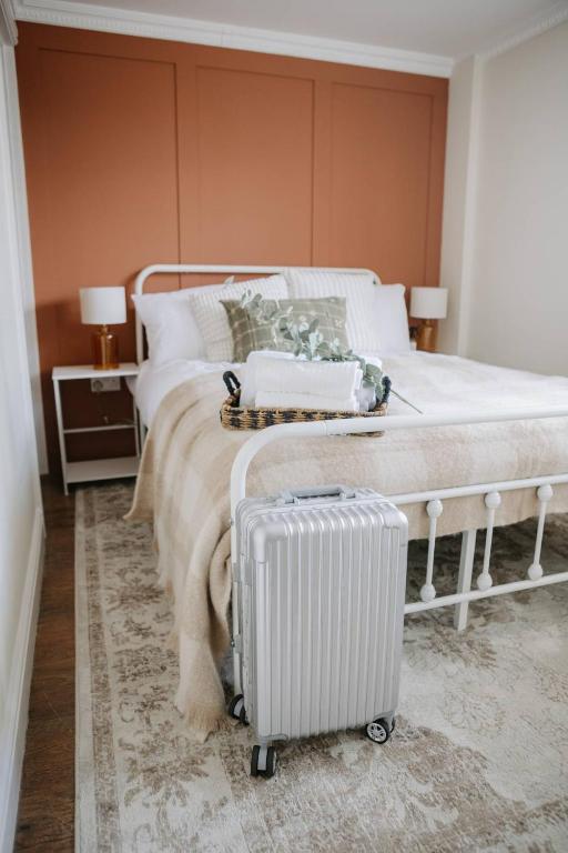 a bedroom with a bed with a suitcase next to it at Room 2 at The Firs in Backwell