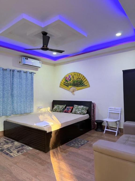 a bedroom with a bed and a blue ceiling at Shankars Resort in Guwahati