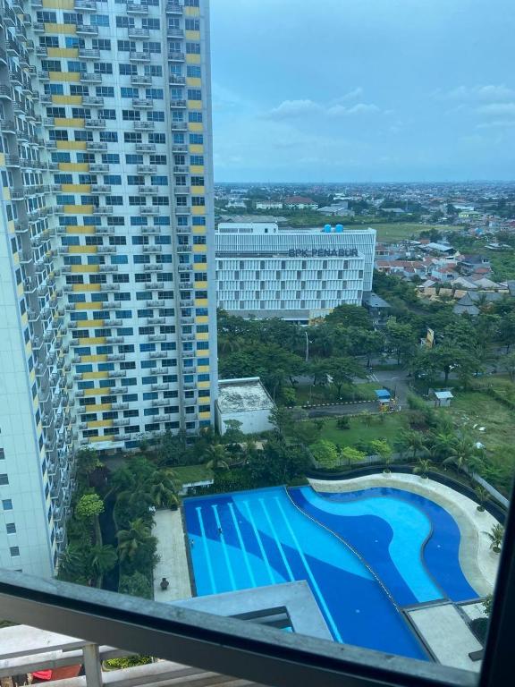 an aerial view of a building and a swimming pool at Springlake apartment b in Rawabugel