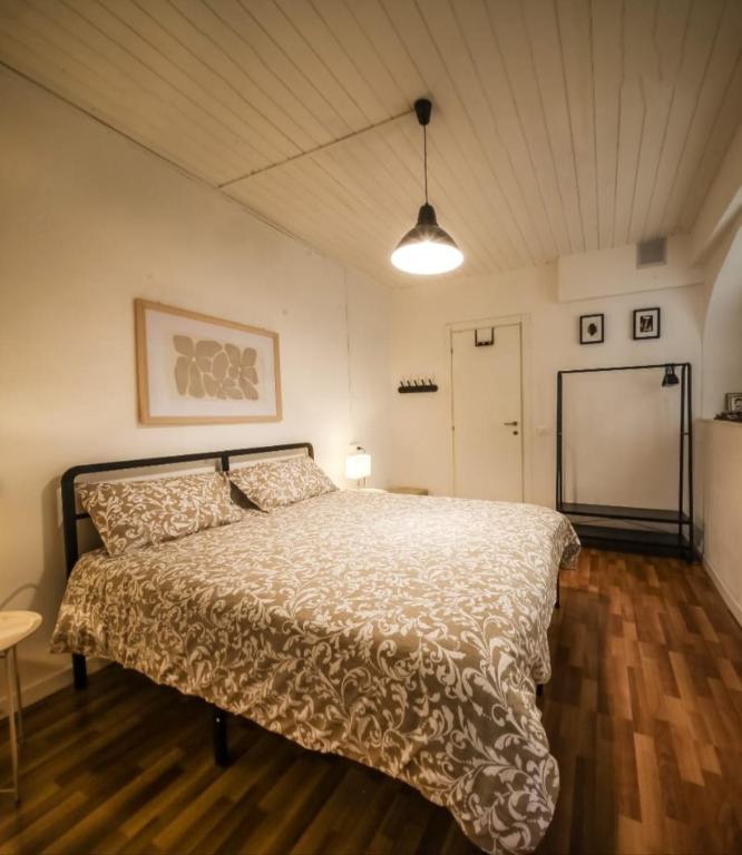 a bedroom with a bed with a white comforter at Civico46 in Domodossola