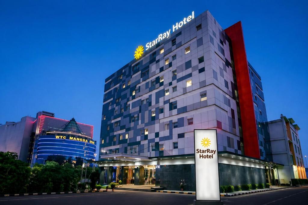 a hotel building with a sign in front of it at StarRay Hotel Jakarta Mangga Dua Square in Jakarta