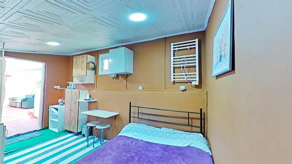 a bedroom with a bed and a table and a kitchen at Apartaments Kandy 2 in Calafell