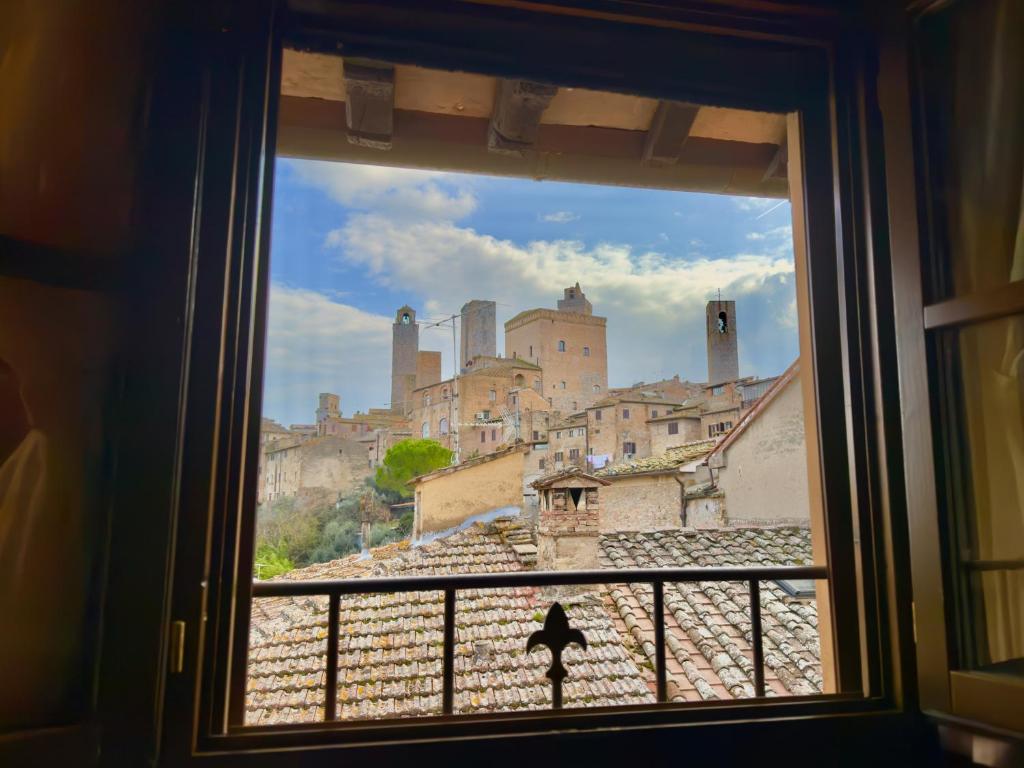 a view of a city from a window at Le Torri View Apartment - San Gimignano in San Gimignano