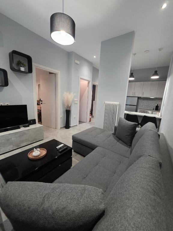 a living room with a couch and a table at SeDi Cozy Apartment in Chios