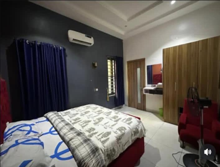 a bedroom with a bed with a blanket on it at Jolie Homes in Lekki