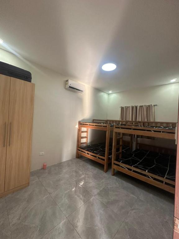 a room with wooden shelves in a room at Jens Residence villa in Bamban