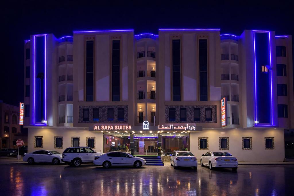 a large building with cars parked in front of it at Elsafa Hotel in Salalah