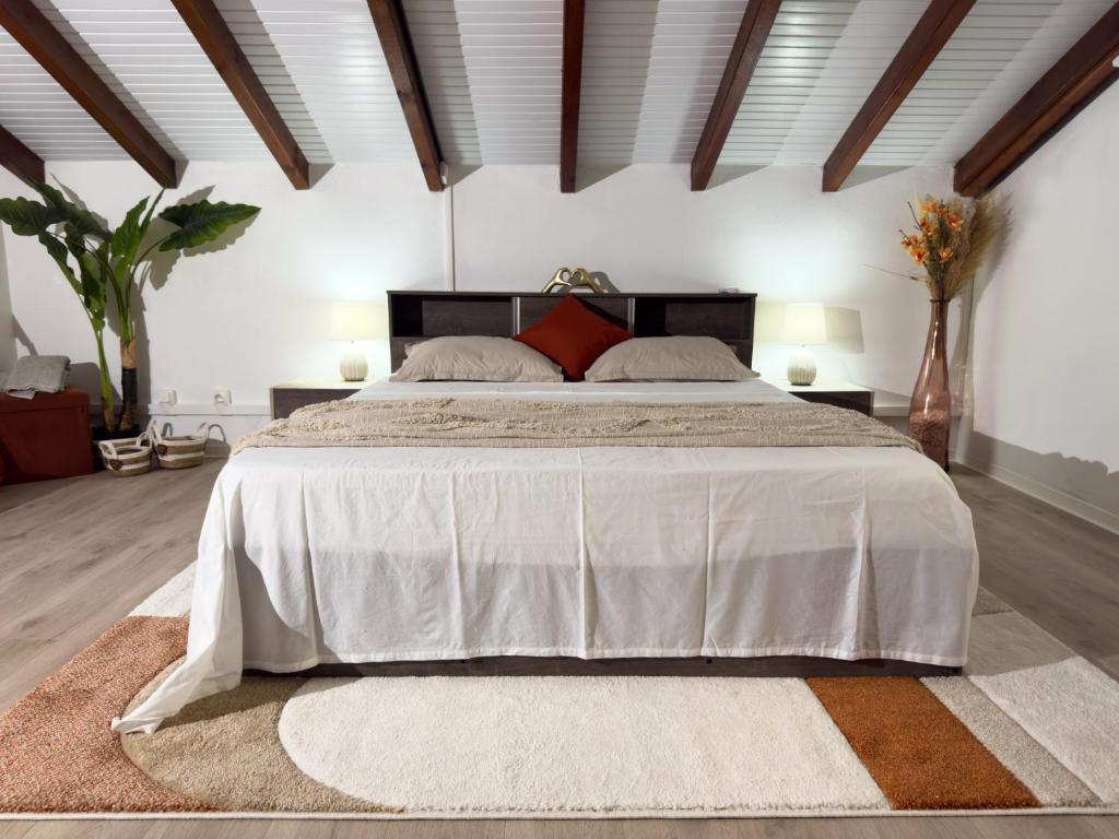 a bedroom with a large bed with a white bedspread at Villa Serenity in Les Abymes