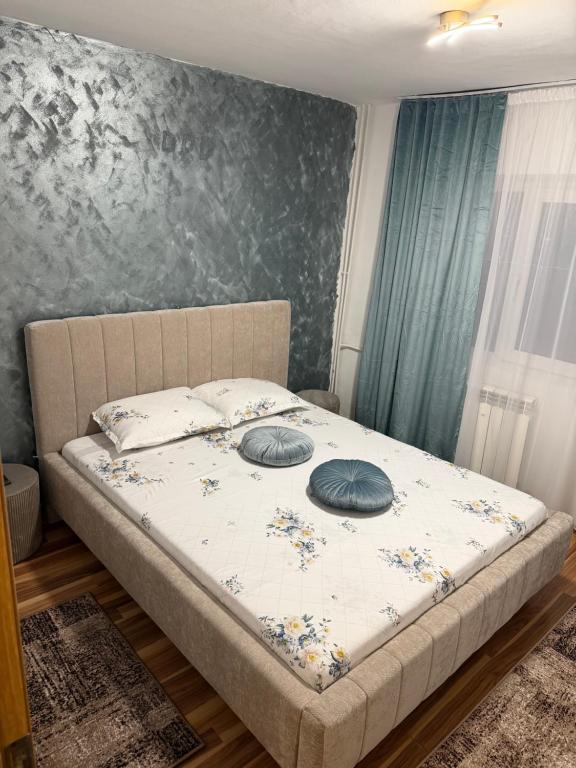 a bed with two pillows on it in a bedroom at Apart1 in Drobeta-Turnu Severin