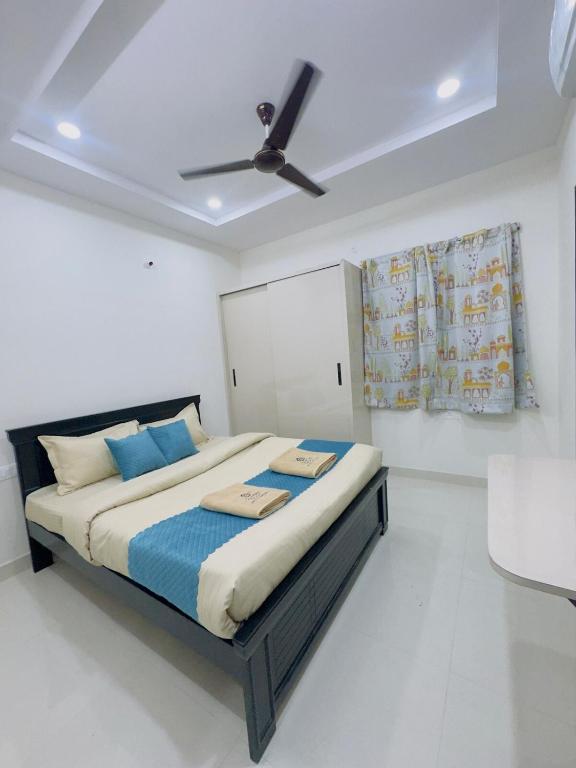 a bedroom with a large bed with a ceiling fan at B2 601 1BHK Flat by Charter Stays in Hyderabad