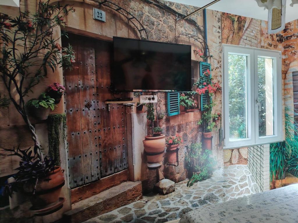 a room with a wall with a tv on it at Villa Abeona in Makarska