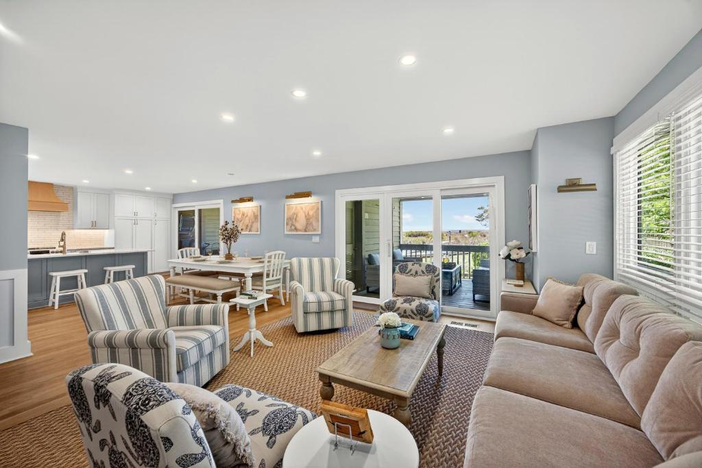 a living room with a couch and chairs and a table at 1395 Pelican Watch in Seabrook Island