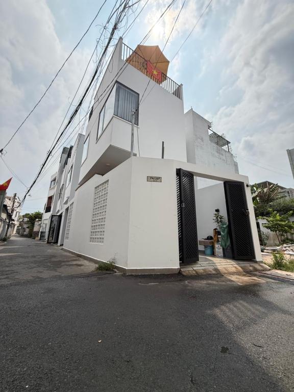 a white building with its doors open on a street at Town House for rent in Thủ Đức in Ho Chi Minh City
