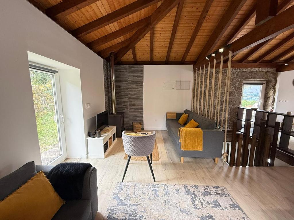 a living room with a couch and a table at Casa do Oliveira - Gerês in Terras de Bouro