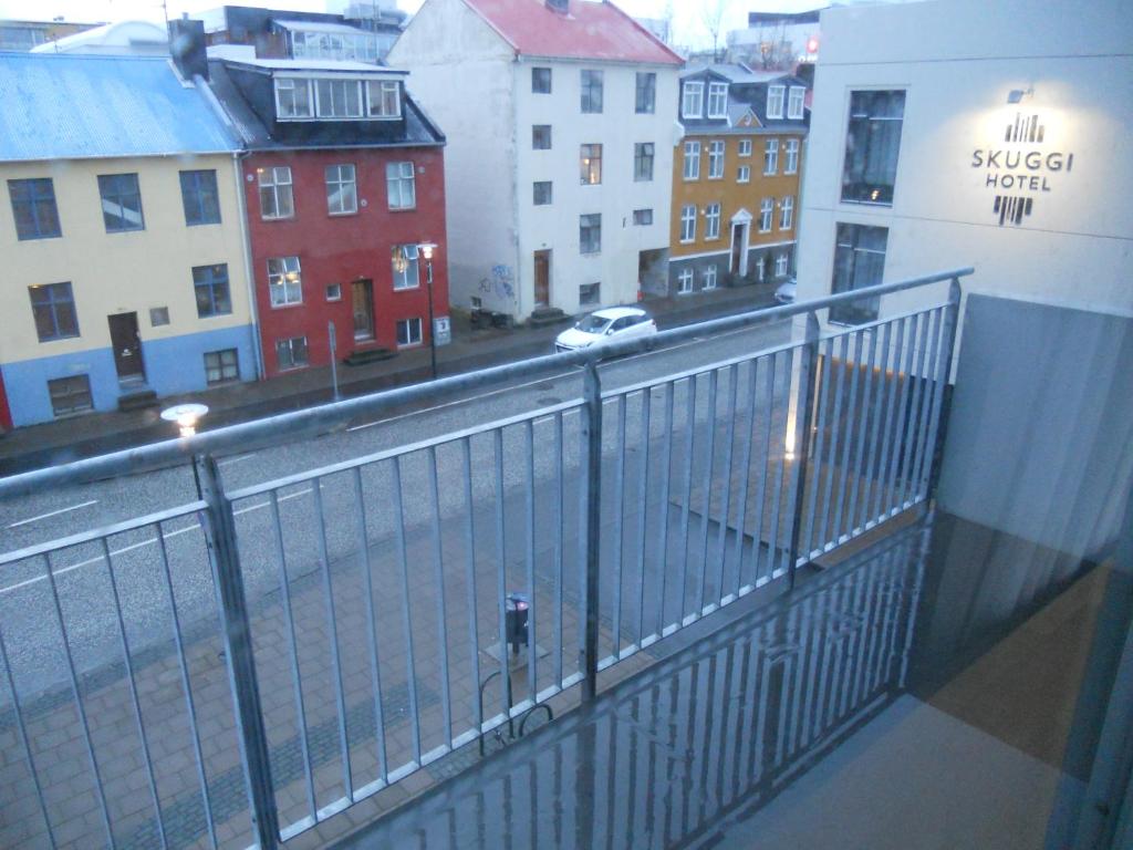 a balcony with a view of a street and buildings at Rez Hlemmur Apartment in Reykjavík