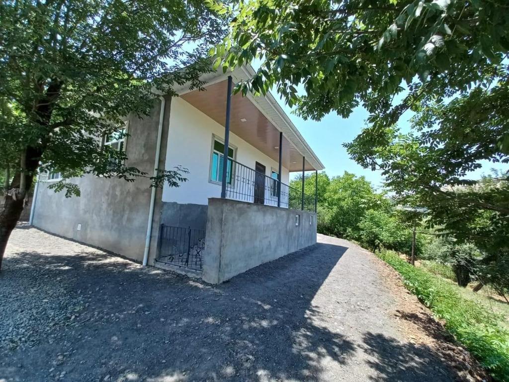 a house on a hill with a fence around it at Naz in Lerik